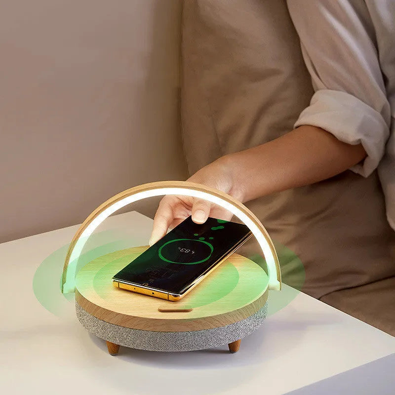 Wireless charging LED night light with Bluetooth speaker in marble pattern finish showing phone holder