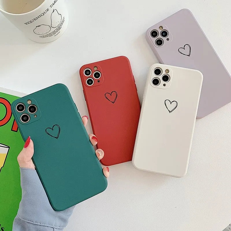 Solid colour silicone TPU back cover case for Apple iPhone on a table, showing colour options.