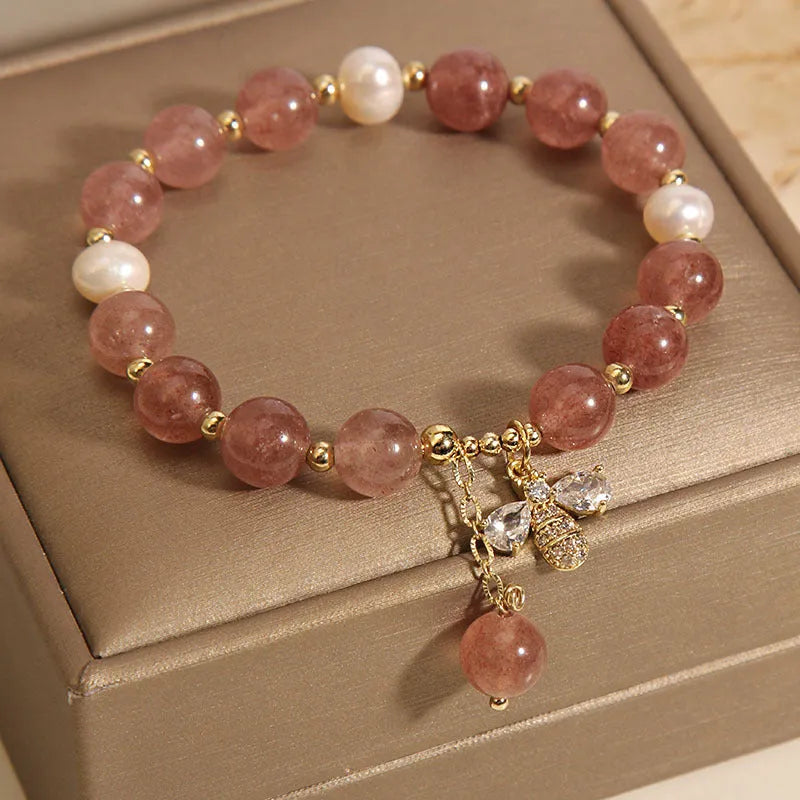 Women's bracelet with strawberry quartz stones, freshwater pearls, and zircon accents on an alloy chain.