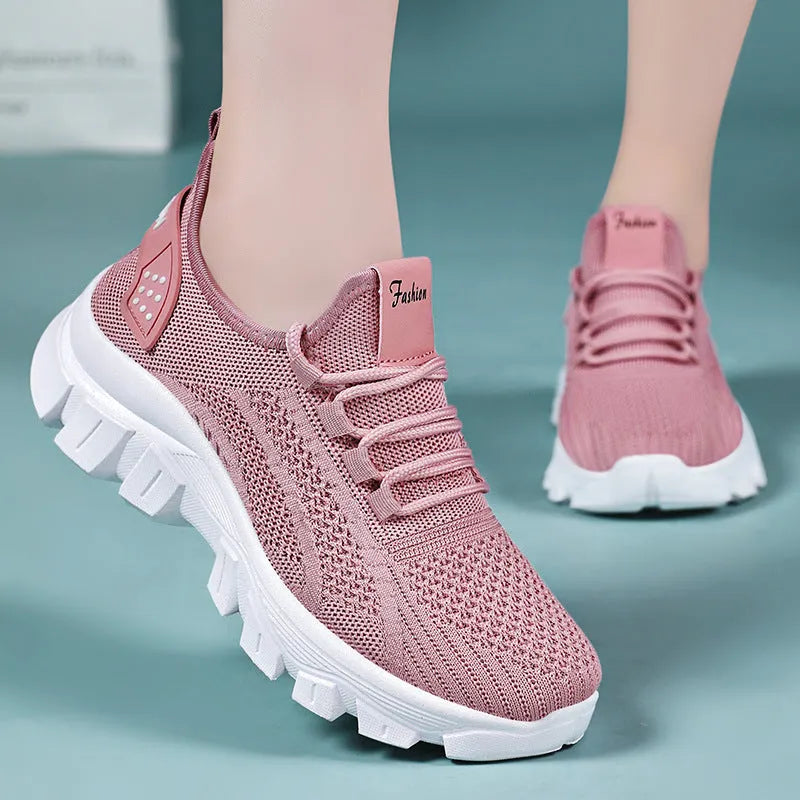 Women's white Flyknit lace-up sneakers with a thick PVC sole and round toe on a neutral background