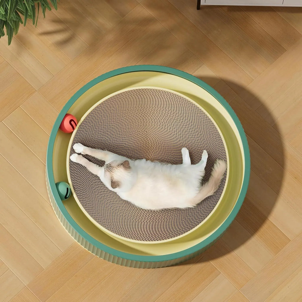 Large green cardboard cat scratching board with three coloured ball toys attached on a flat surface.