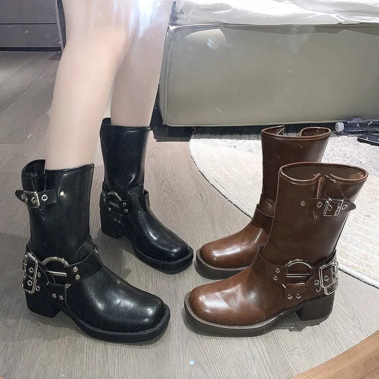 Black platform women's boot with a belt buckle on the shaft, mid-calf height.