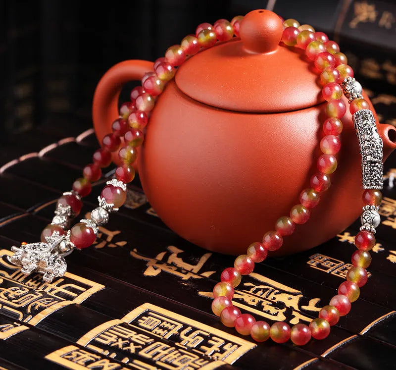 Natural watermelon crystal bracelet with Chinese knot fastening showing bi-colour gemstone beads