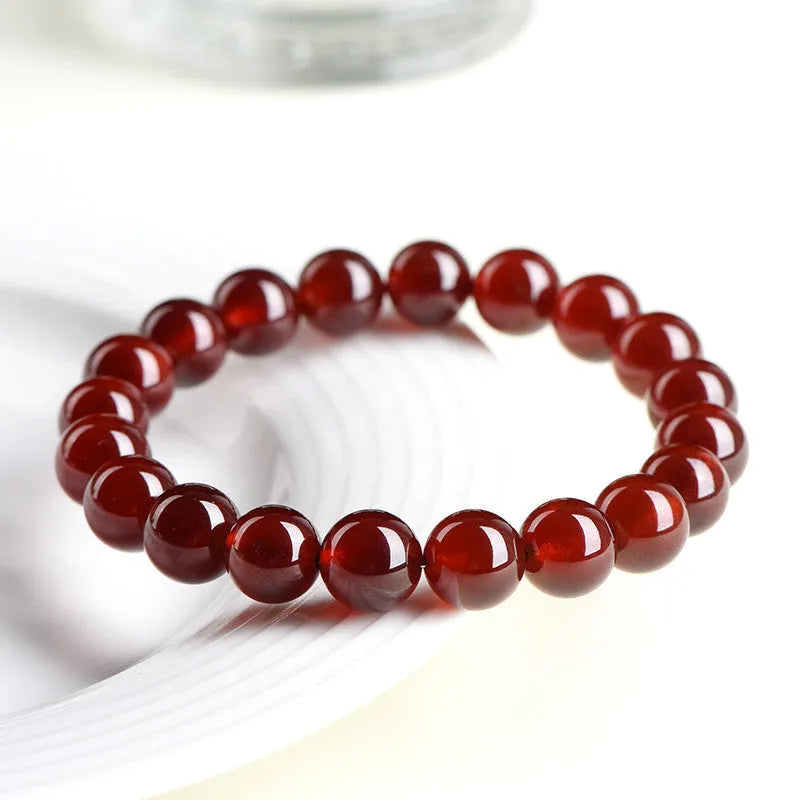Natural orange red garnet crystal ball bracelet with ruyi charm detail in retro unisex style