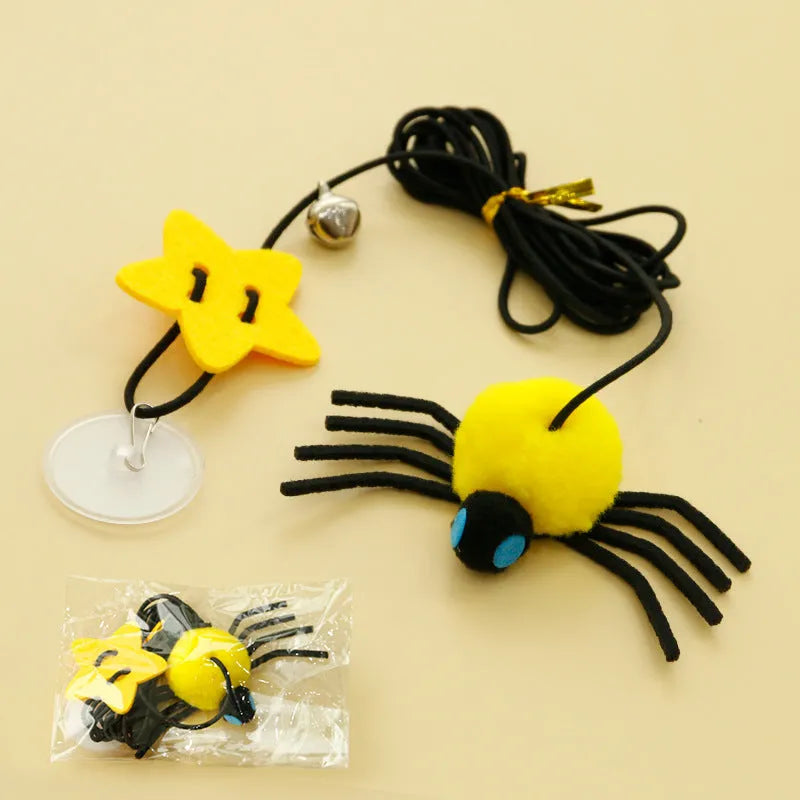 Red and yellow hanging door cat toy with feather, bell, spider, and elastic rope for interactive pet play
