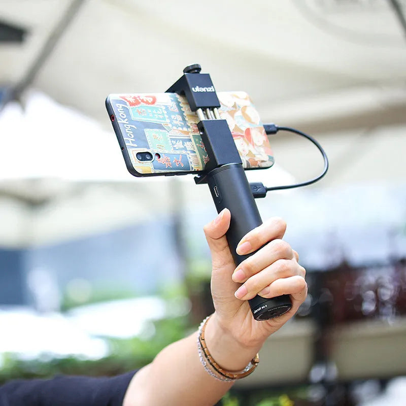 Black aluminium alloy portable power bank with a carry handle and strap, showing compact size