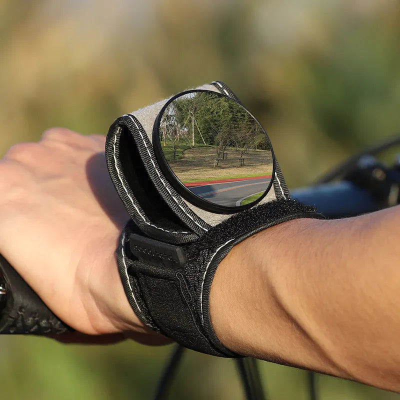 Black nylon bicycle wrist-mounted rear-view mirror for cycling safety.