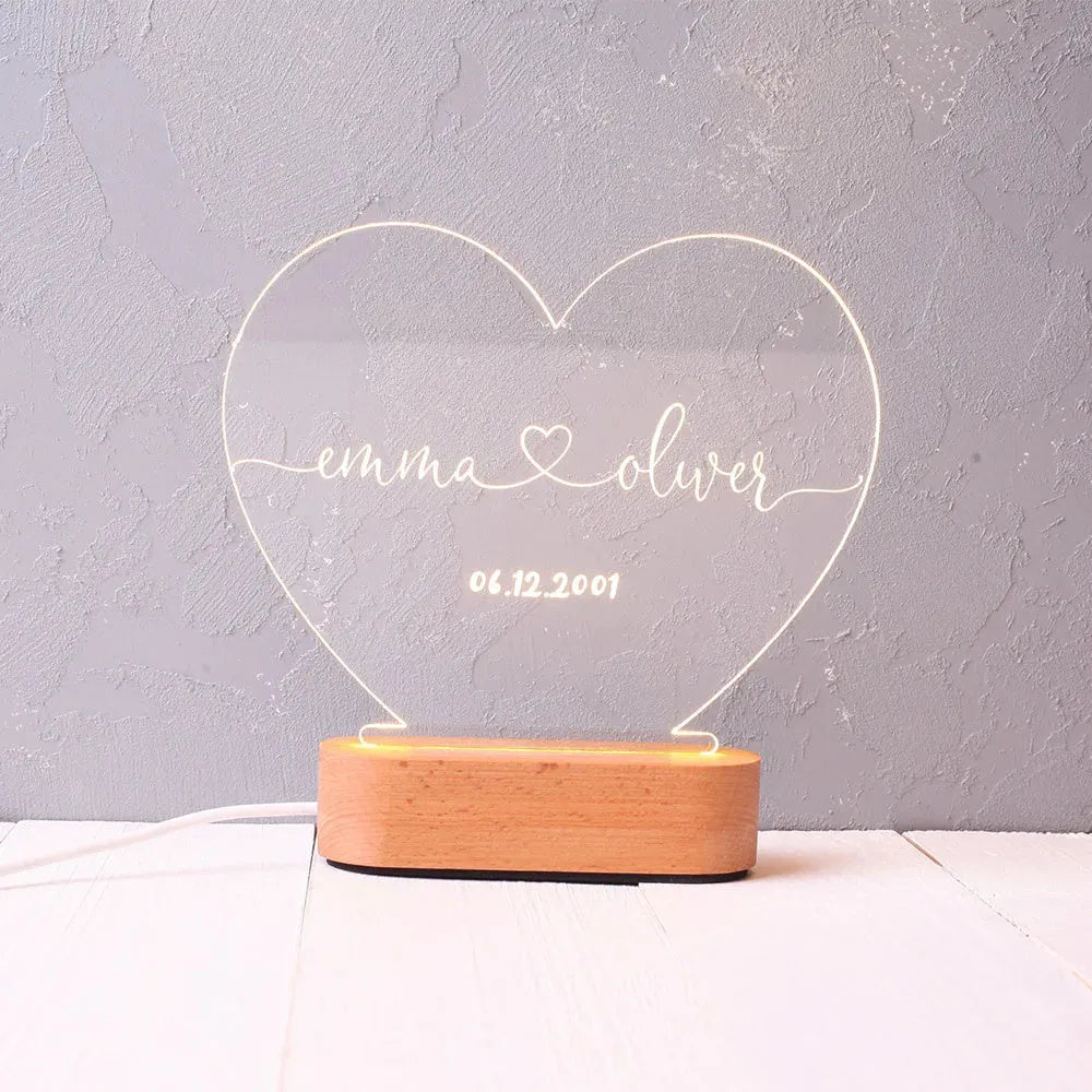 Personalised acrylic LED night light showing custom names and dates with transparent 20x11.5cm design