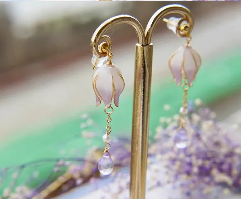 Silver plated gradient colour amethyst water drop tassel ear studs with flower core pattern on white background