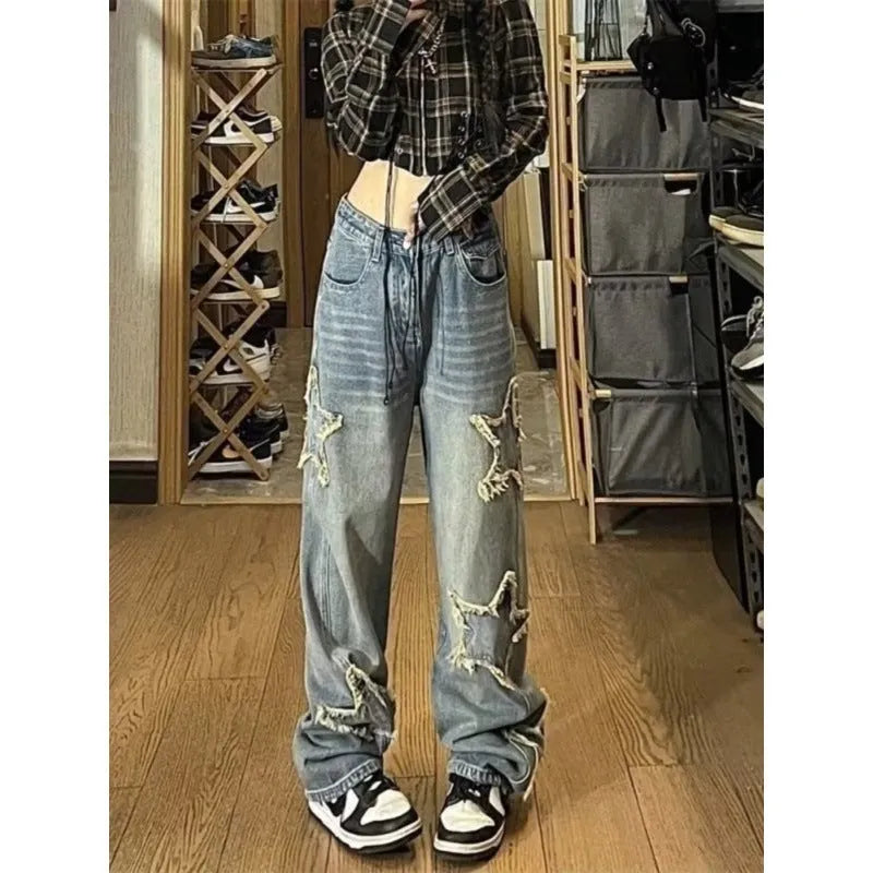 Blue high waist wide-leg denim trousers on a hanger, showing straight leg cut.
