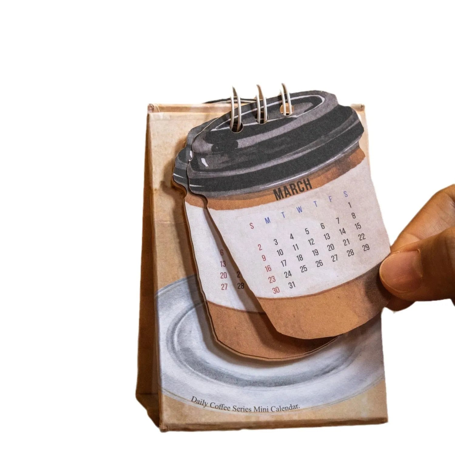 Mini 2025 desk calendar with simple modern design on a desk.