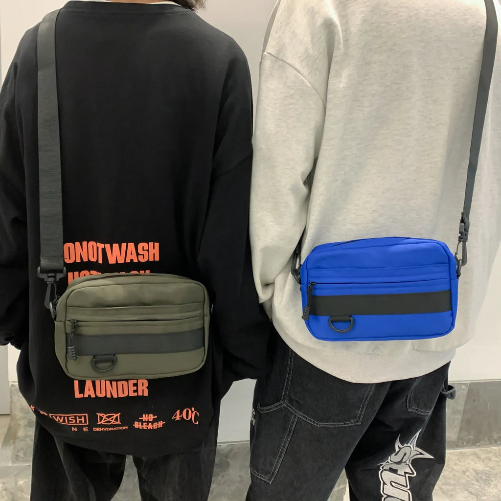 Men's street style nylon messenger bag in black with crossbody strap and sewing thread detailing