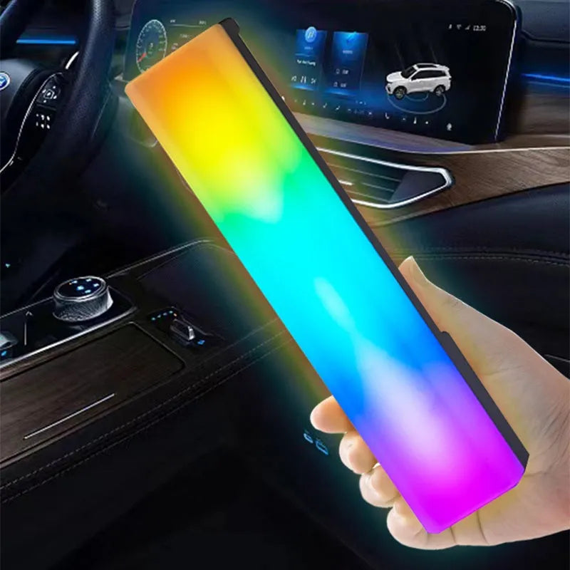 Black and white 3D RGB music rhythm ambiance lamp on a table with USB cable.