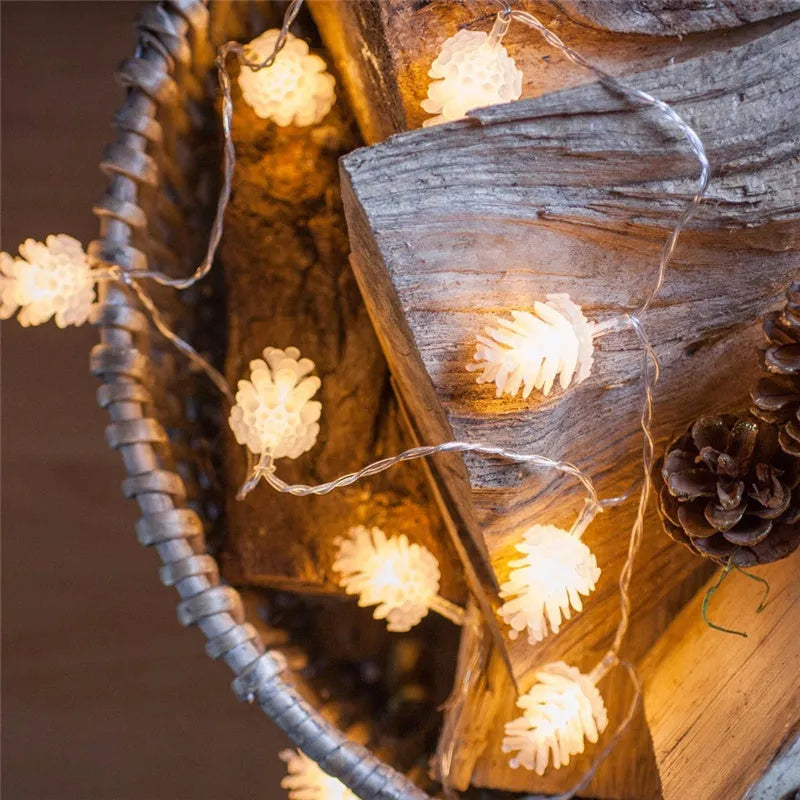 Warm white LED pine cone string lights with plastic shells in battery-powered decorative lighting