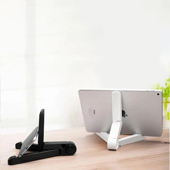 Black foldable tablet holder open in landscape mode holding a smartphone, showing its compact size and non-slip rubber surface.