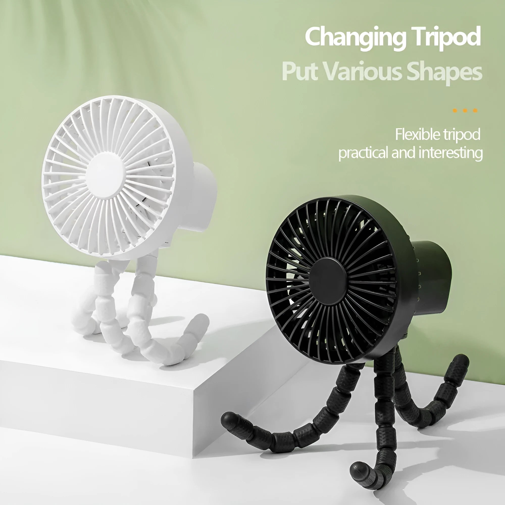 Small adjustable tripod desktop fan with bending head, shown in black on a desk.
