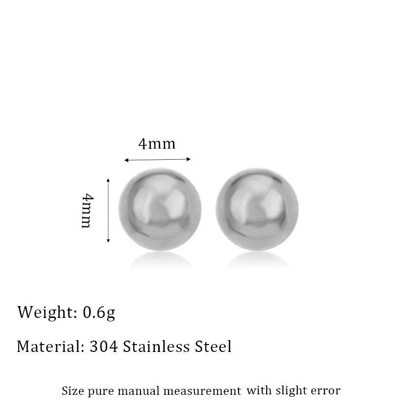 Minimalist round ball stud earrings in gold and silver tones on a plain background.