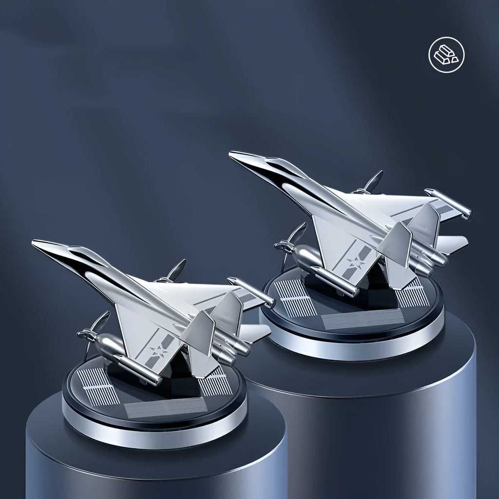 Solar powered rotating silver fighter jet perfume ornament with aluminium alloy base on a car dashboard