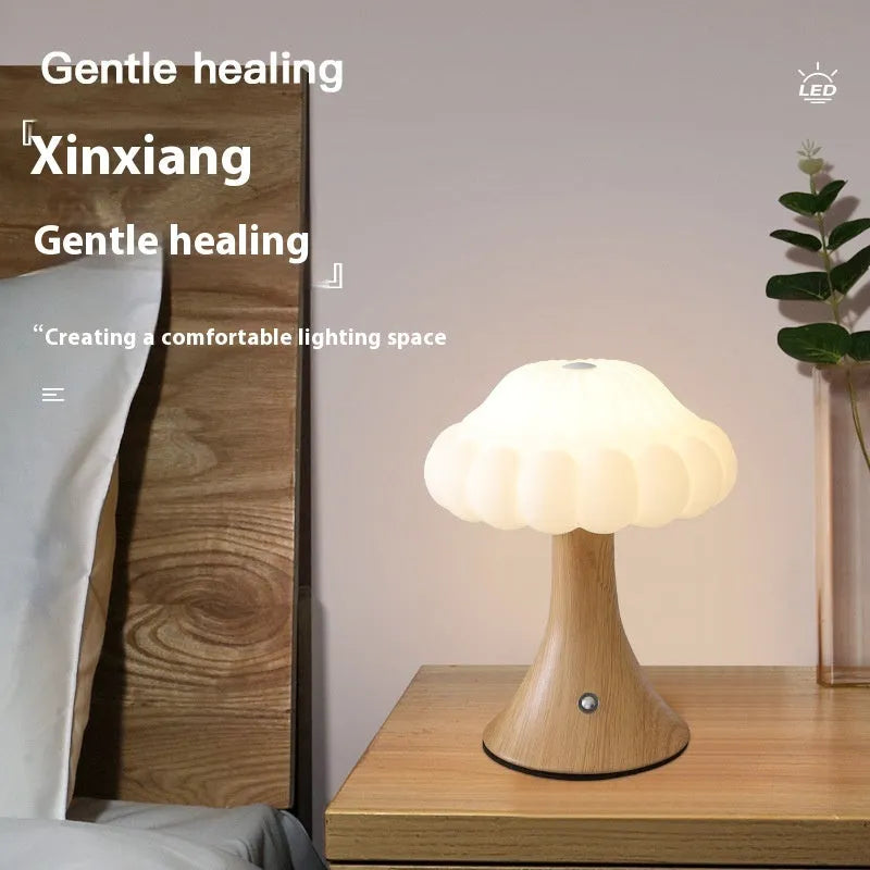Wood grain coloured mushroom-shaped touch lamp with USB charging port on a table