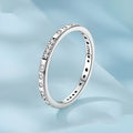 Close-up of a women's oxidised black silver alloy ring with an etched 'I love you' moss password design on a simple band.