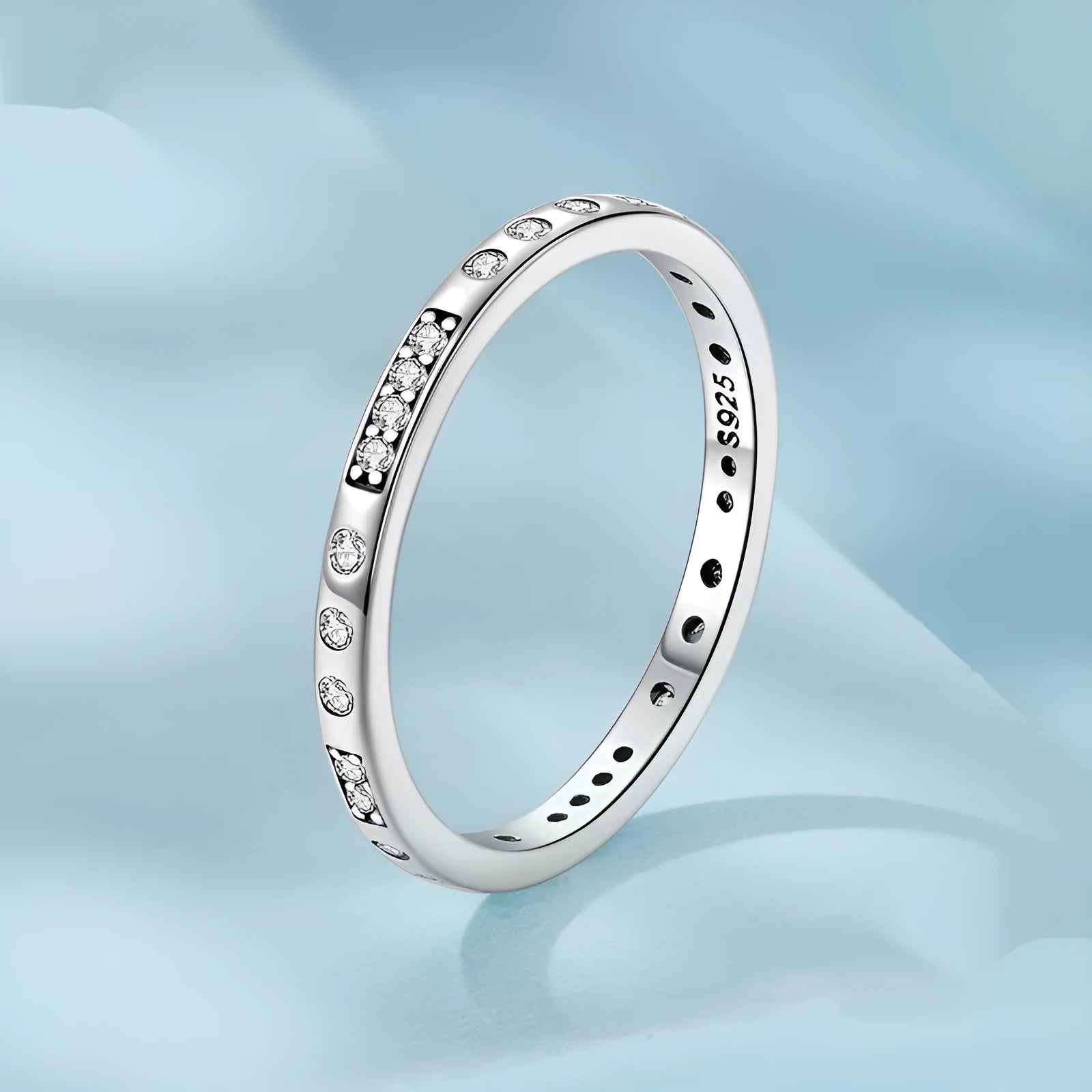 Close-up of a women's oxidised black silver alloy ring with an etched 'I love you' moss password design on a simple band.