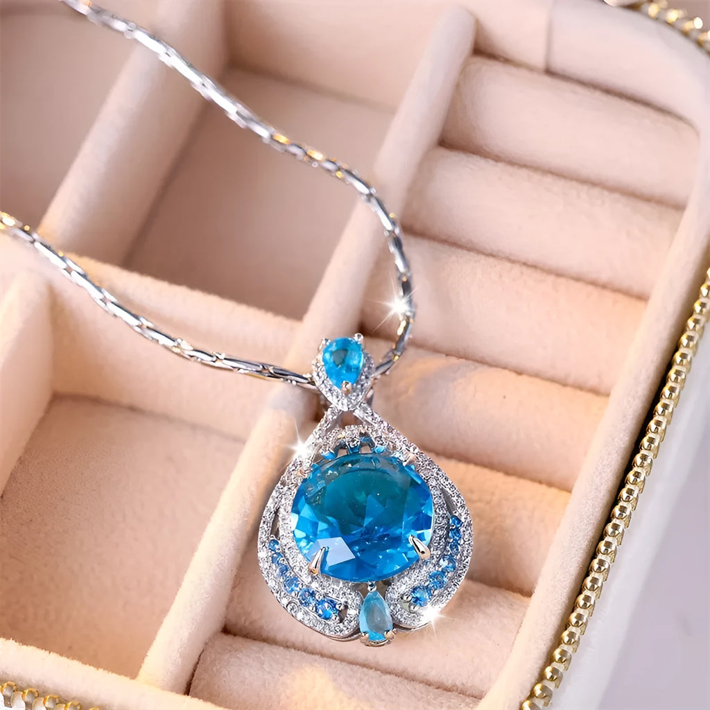 Blue geometric pendant necklace with fireworks cut gems and water wave chain