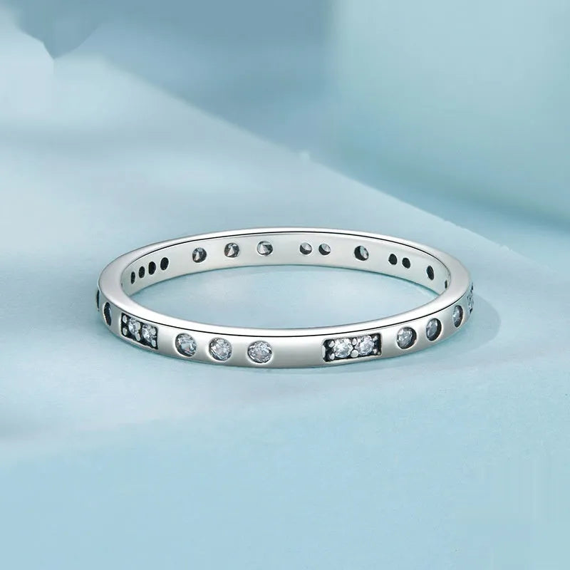 Close-up of a women's oxidised black silver alloy ring with an etched 'I love you' moss password design on a simple band.