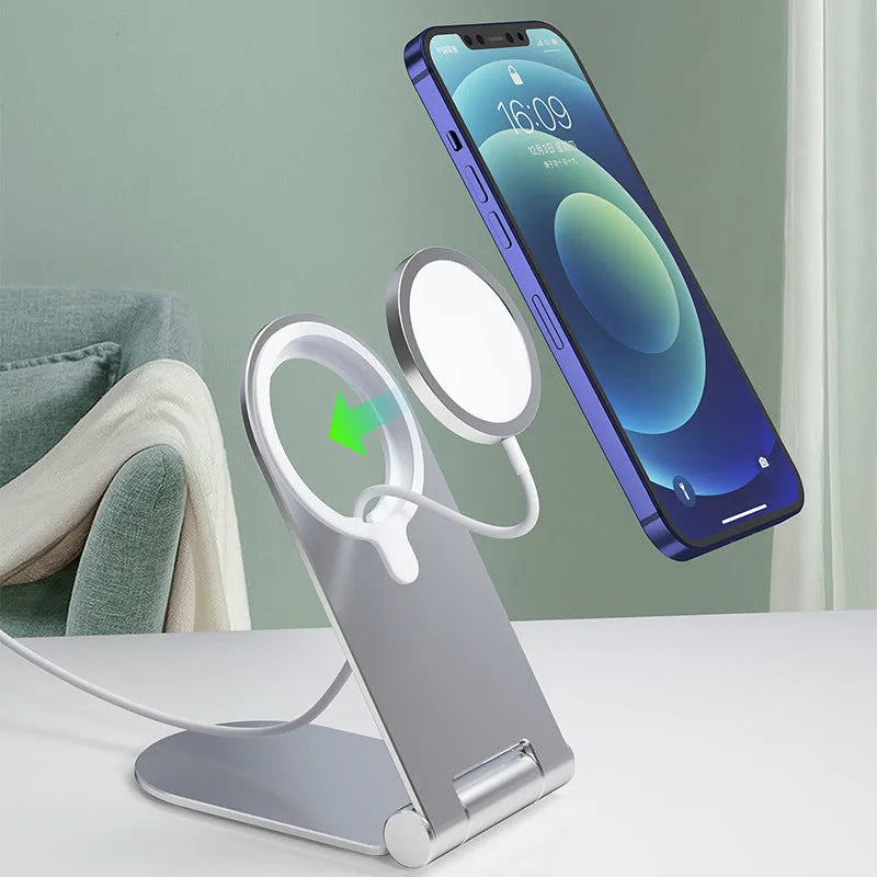 Silver vertical adjustable magnetic phone bracket on a desk, holding an iPhone 12.
