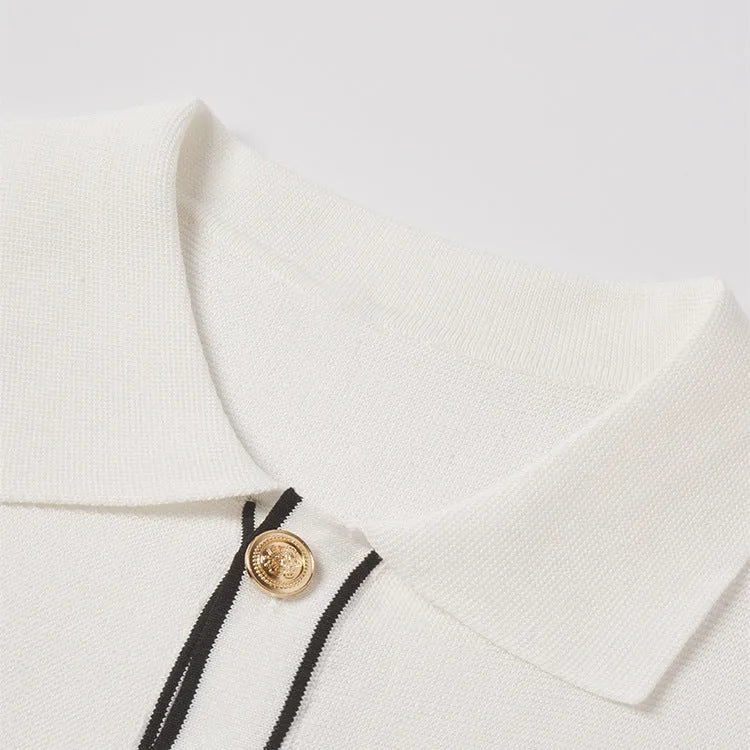 White women's short-sleeve cardigan with contrasting colour lapels laid flat.