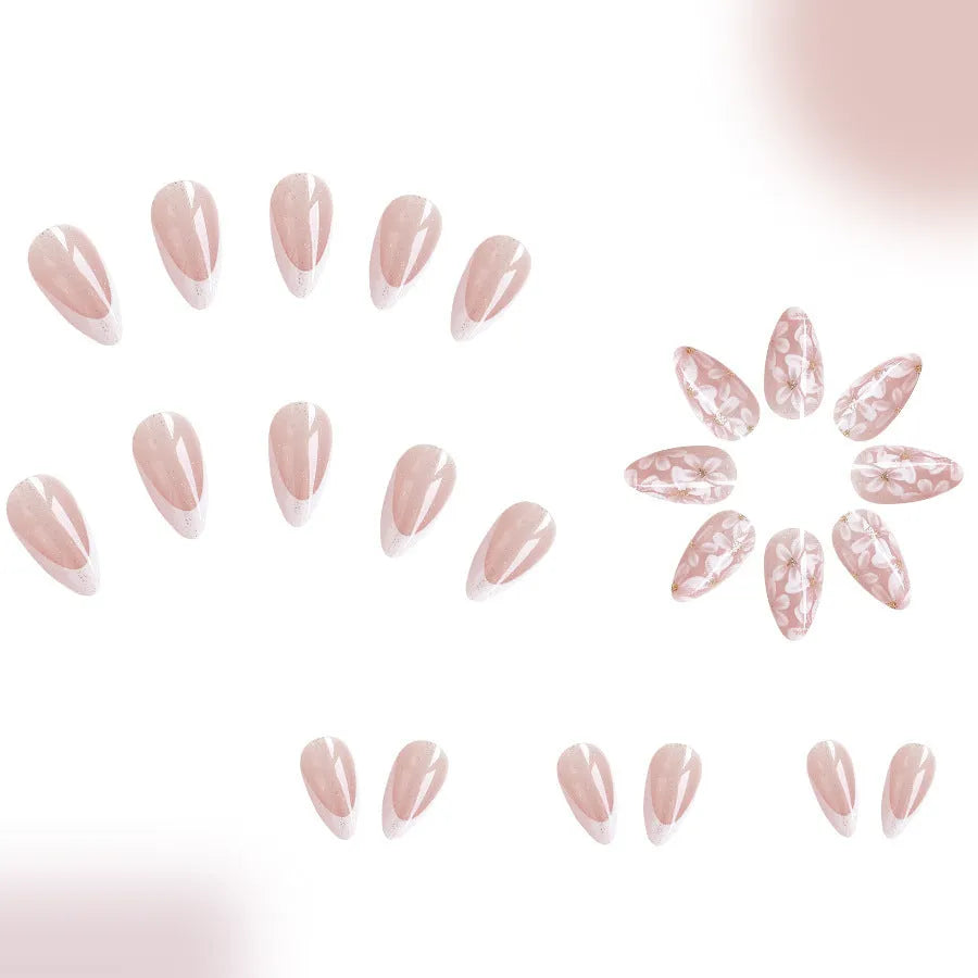 Short glossy almond-shaped press-on nails with French style, floral designs and glitter accents in C625 colour