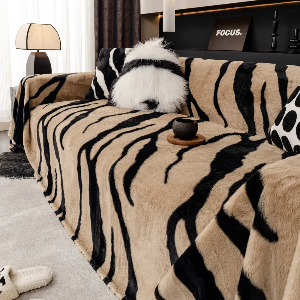 Zebra pattern flannel sofa cover in a caramel colour, shown draped over a sofa.