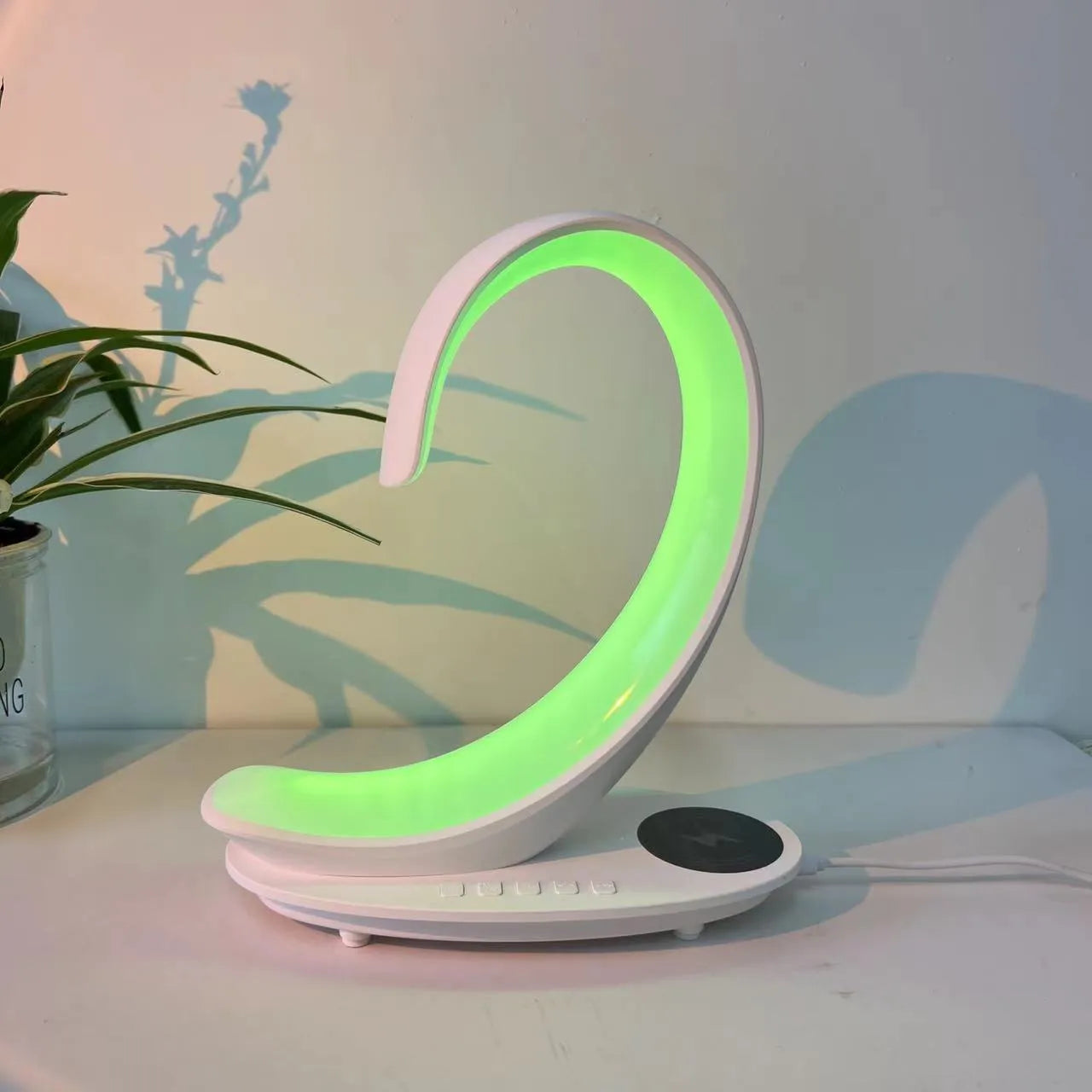 White swan-shaped desktop wireless charger with Bluetooth speaker and colourful ambient lighting
