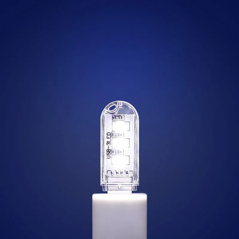 Small white USB LED night light showing warm and white light colour options