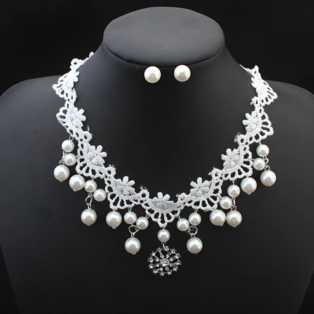 Three-piece white pearl jewellery set with necklace, earrings, and bracelet on display