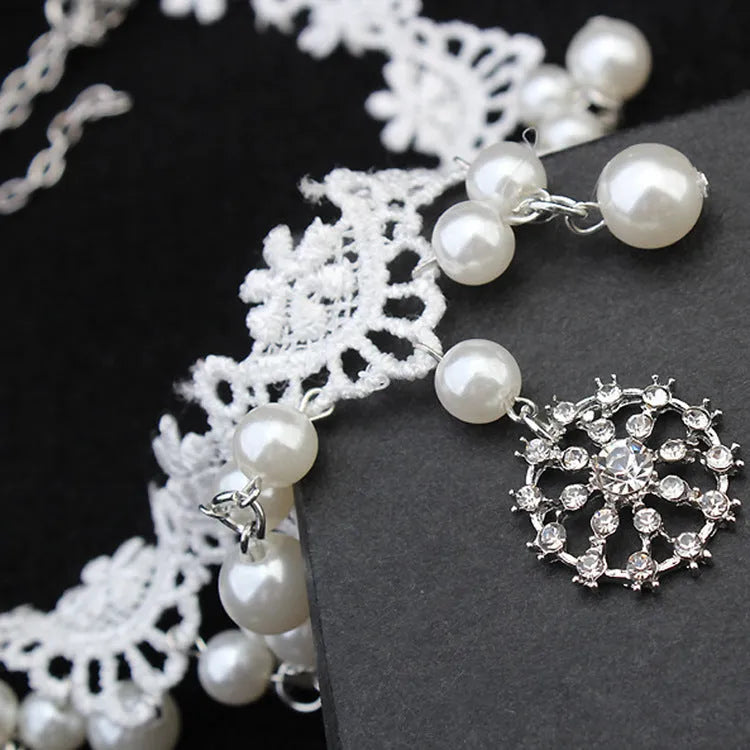 Three-piece white pearl jewellery set with necklace, earrings, and bracelet on display