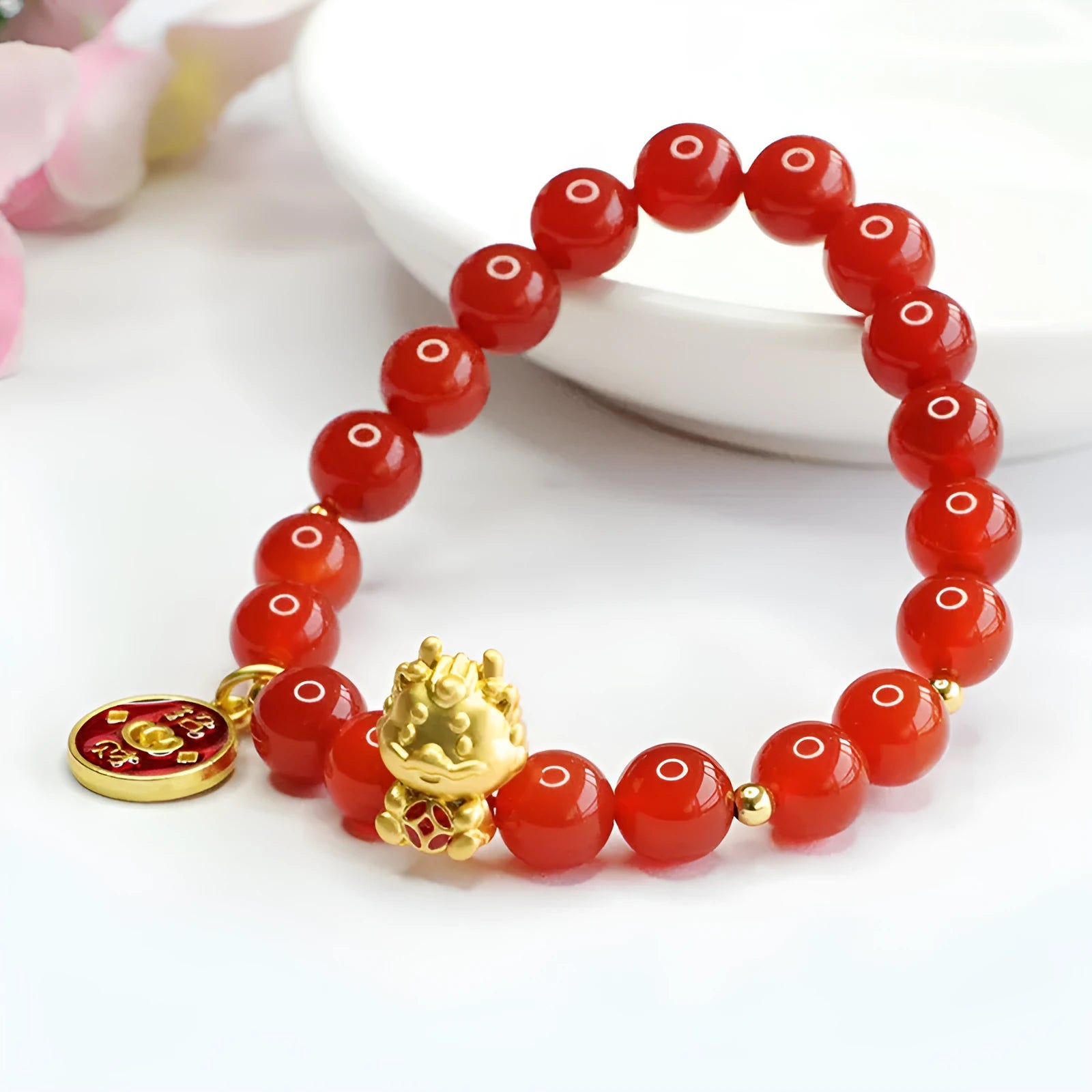 Close-up of a red agate bead dragon zodiac bracelet with 8mm beads in a Chinese style.