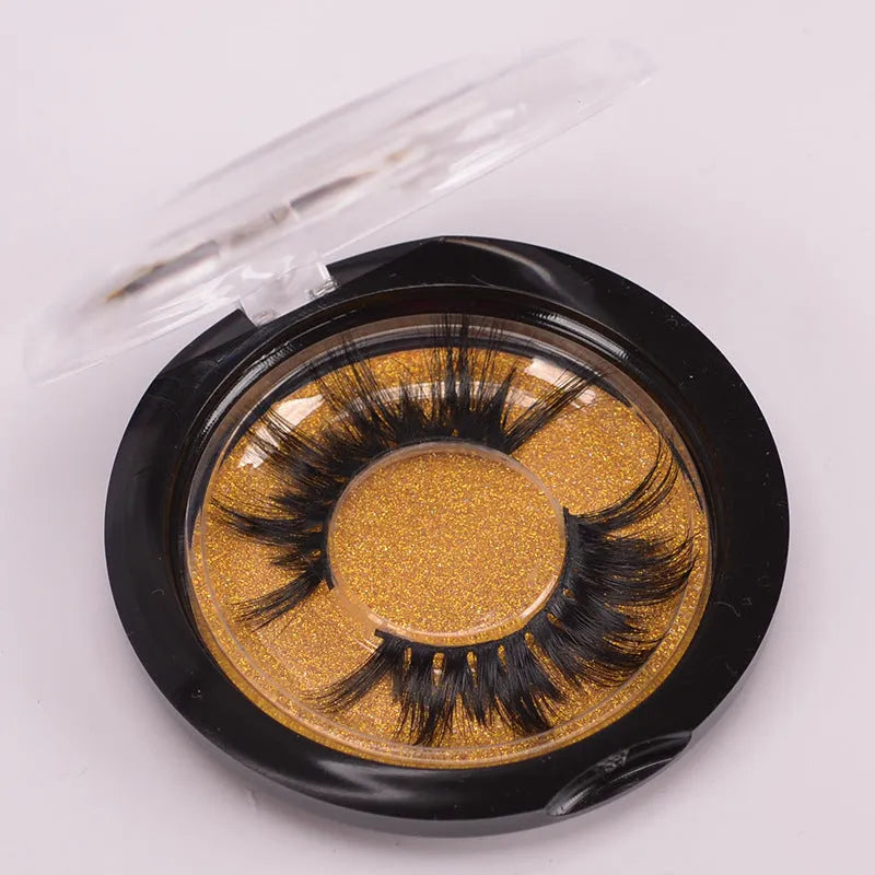 Handmade 5D mink false eyelashes set with brush and storage cap on a white background.