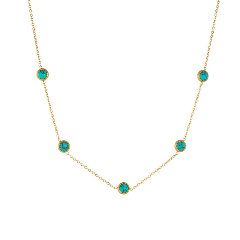 Round turquoise stainless steel earrings and necklace set on display