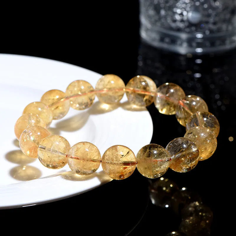 Natural yellow citrine bracelet with geometry-shaped beads in various sizes on display