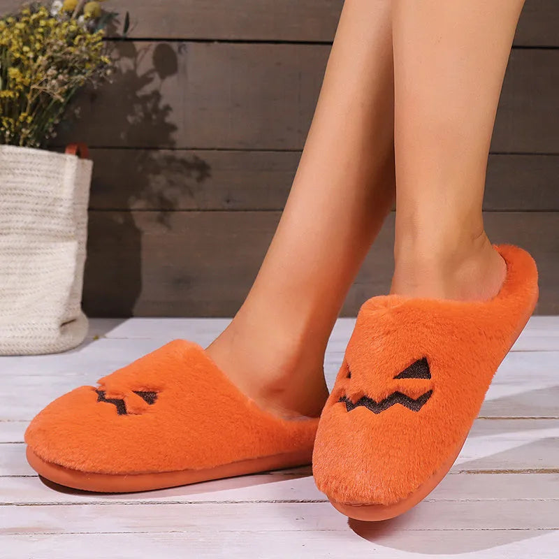 Orange Halloween pumpkin slippers with coral velvet upper and plush lining for indoor winter wear