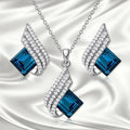 Glass pendant and alloy cross chain necklace with matching electroplated ear studs jewellery set in two style colours.