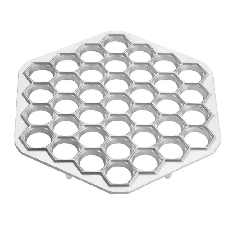 Silver aluminum alloy 37-hole dumpling mold on a plain background