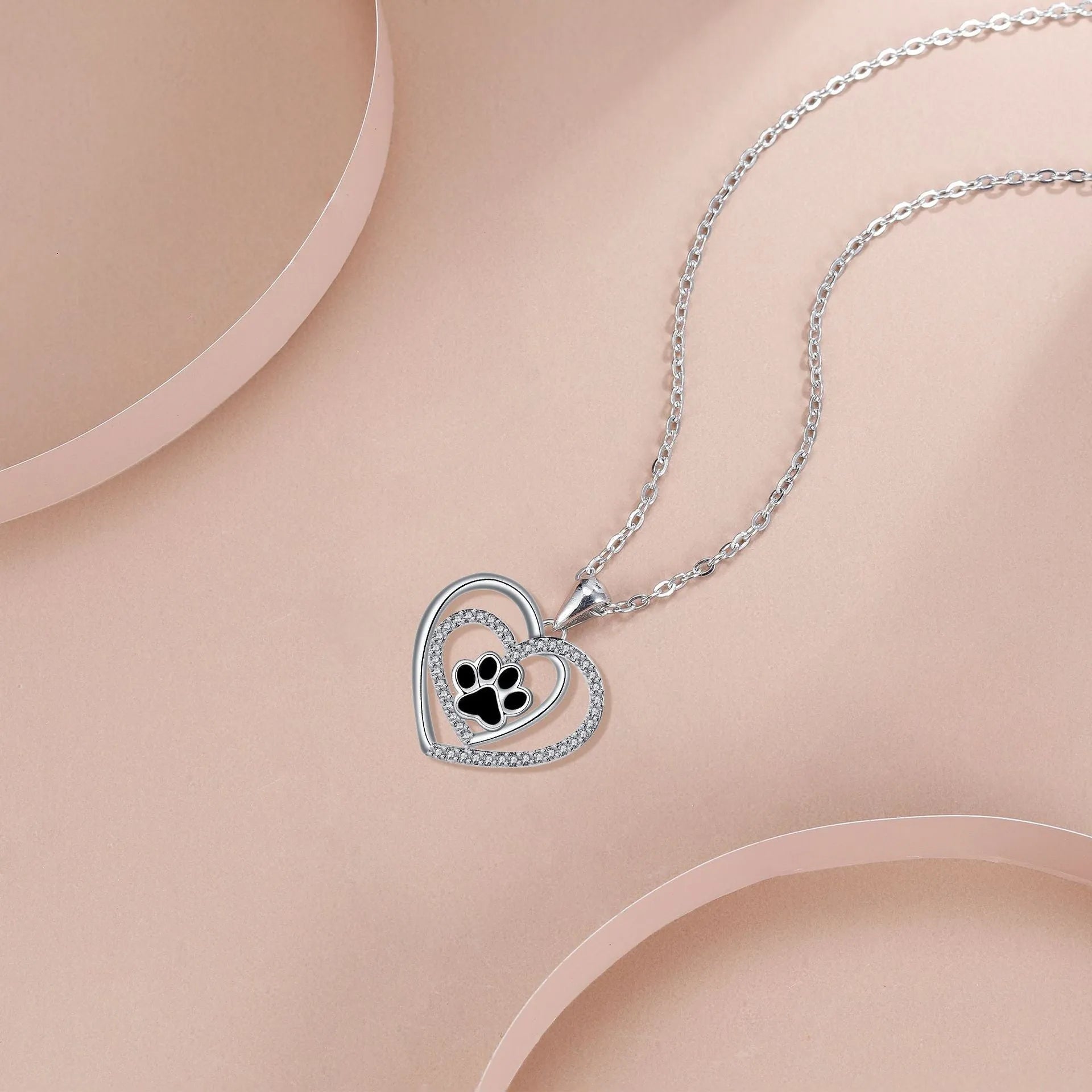 Women's dog paw print heart necklace on a cross chain, copper electroplated.