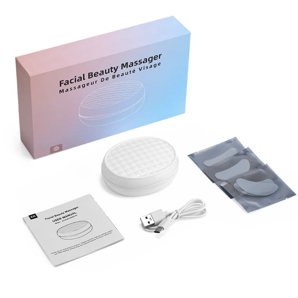 White wireless red light and EMS eye and face massager for home beauty treatment.