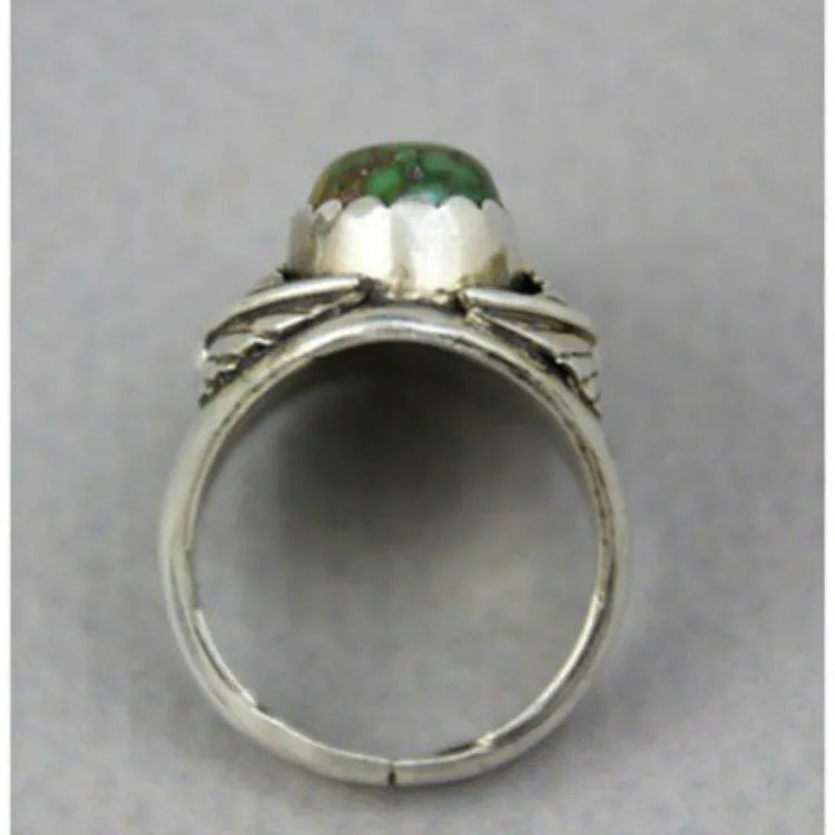 Close-up of a turquoise geometric women's alloy ring on a hand, showing its angular shape and metallic finish.
