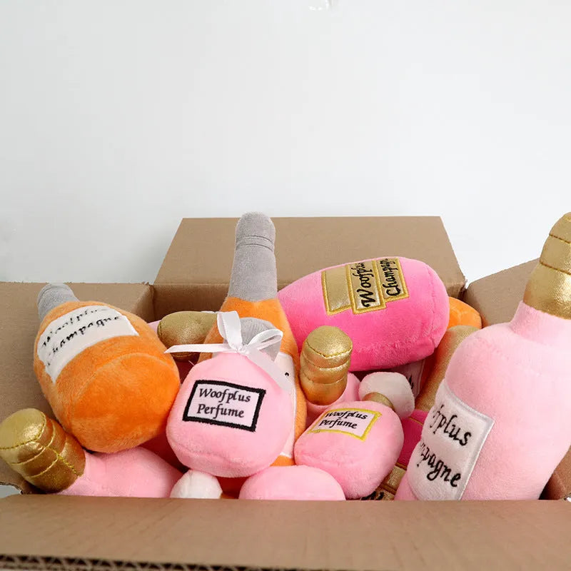 Soft plush pet toy shaped like a wine bottle in assorted colours including green, red, and black.