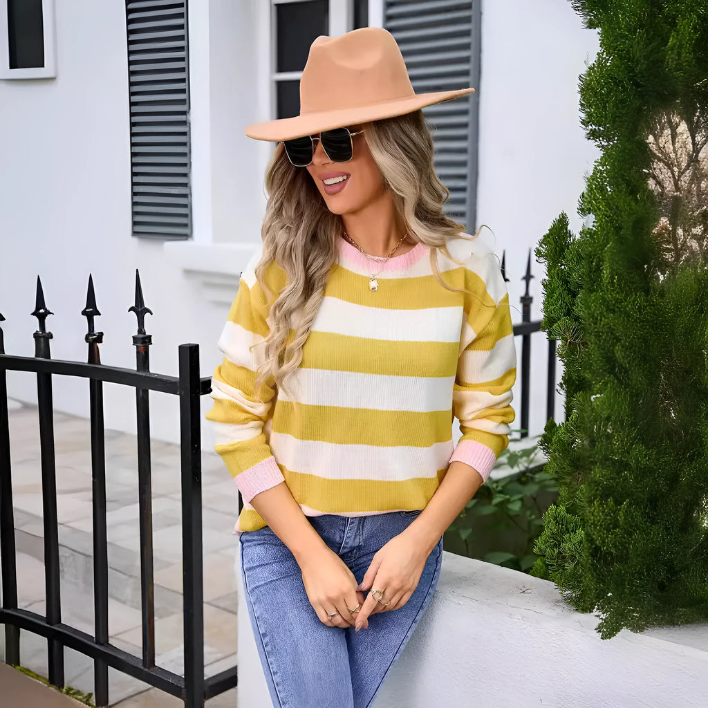 Blue striped women's loose-fit long sleeve acrylic sweater on a hanger.