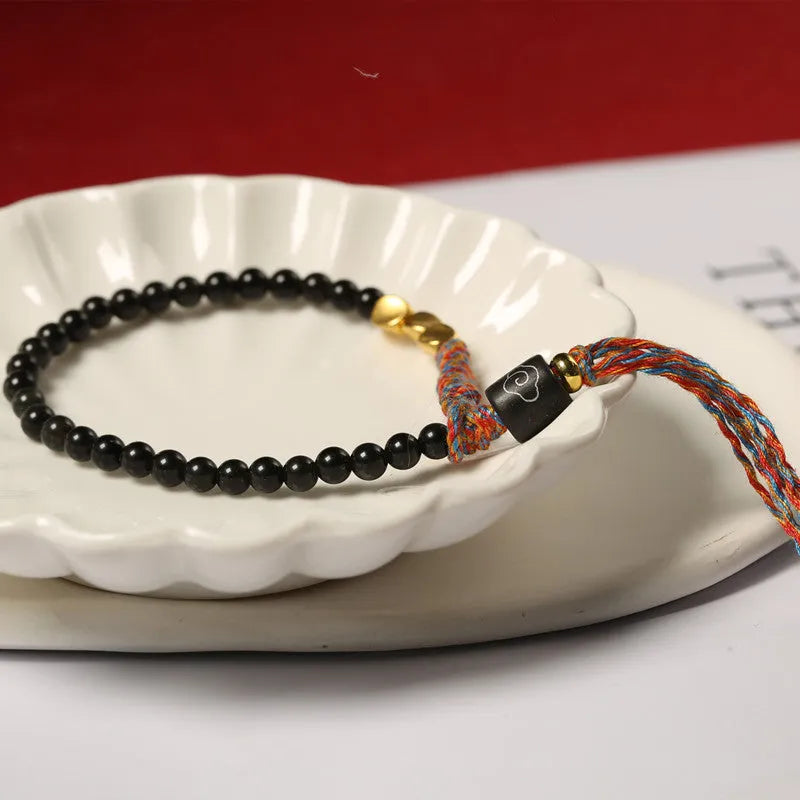 Hand-woven obsidian carrying strap showing 4mm width and adjustable length for phones, keys, or cameras