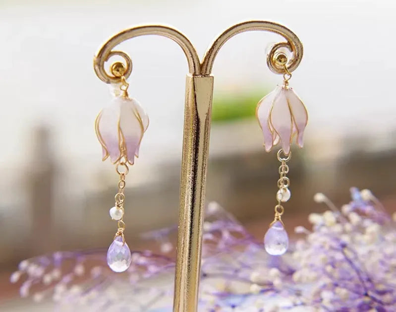 Silver plated gradient colour amethyst water drop tassel ear studs with flower core pattern on white background