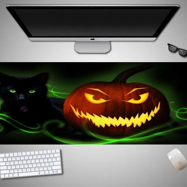 Oversized Halloween-themed rubber cloth mouse pad on a desk, showing non-slip base and large surface area.